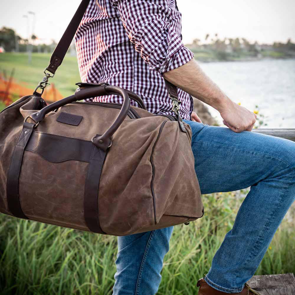 https://www.sportsmangear.com/cdn/shop/products/Mission-Mercantile-Leather-Goods-Campaign-Waxed-Canvas-Large-Field-Duffle-Bag-2_1000x.jpg?v=1669072630